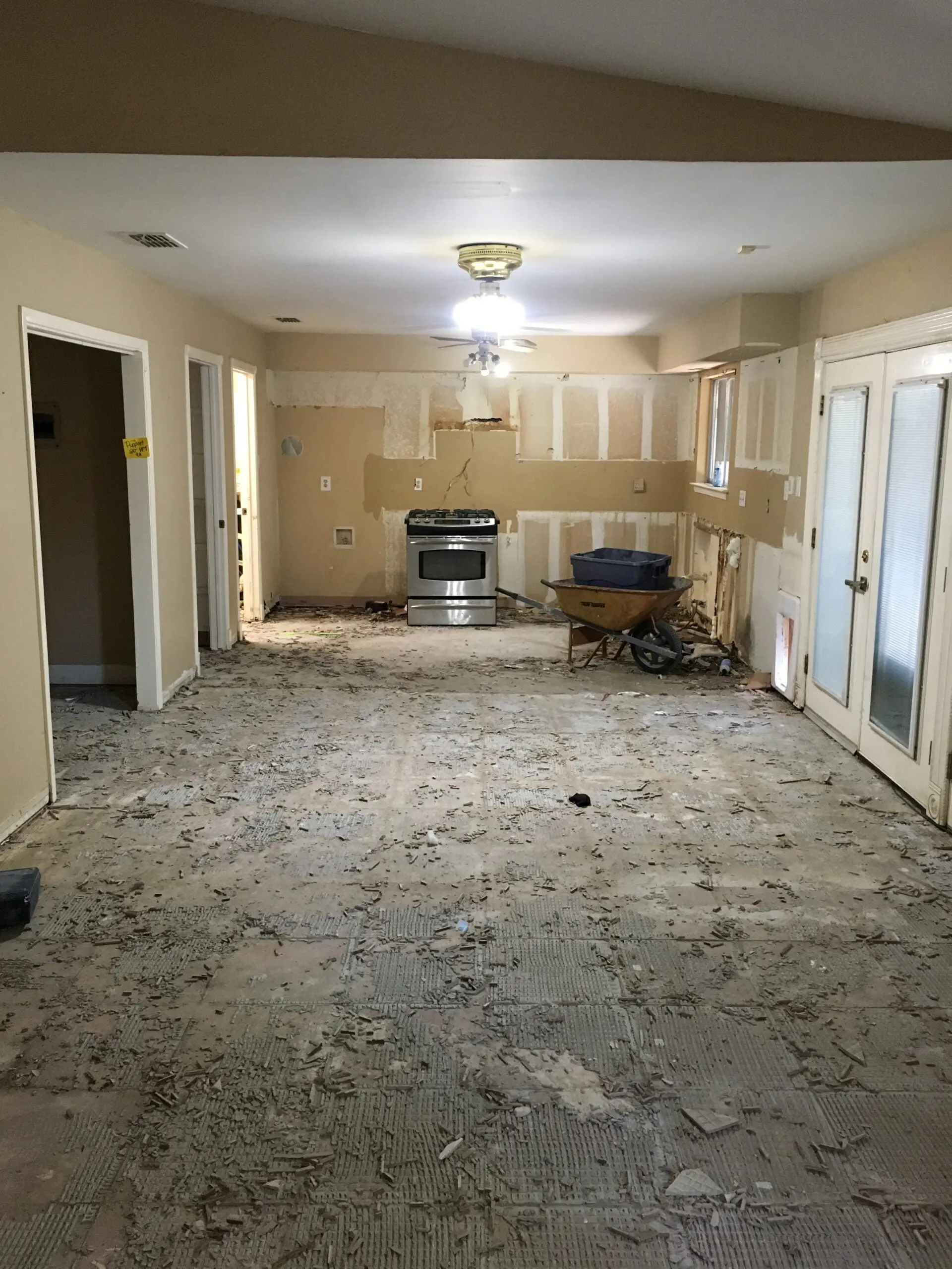 an empty room with a stove and a refrigerator