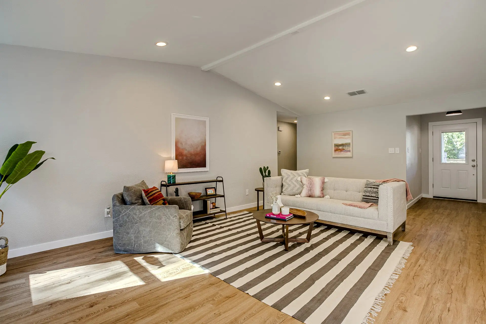 a living room filled with furniture and a wooden floor