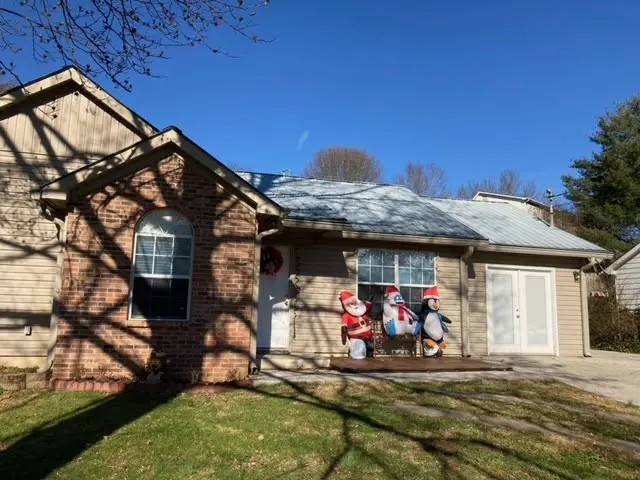 a house decorated for christmas with inflatable snowmen