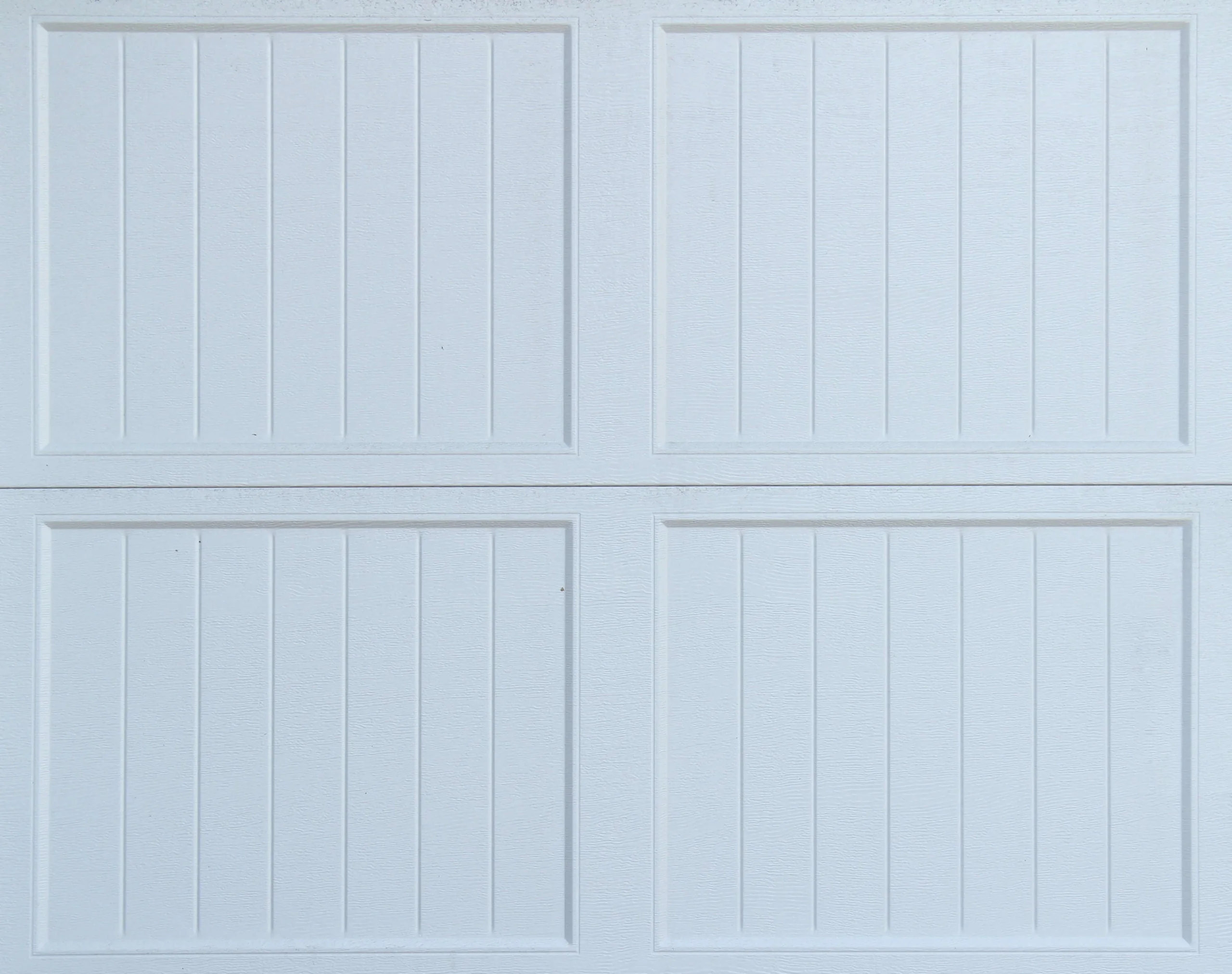a white garage door with four panels on it