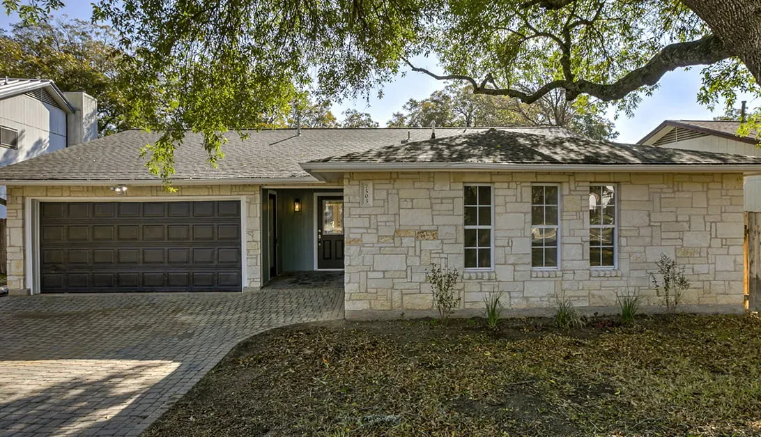 a house with a tree in front of it