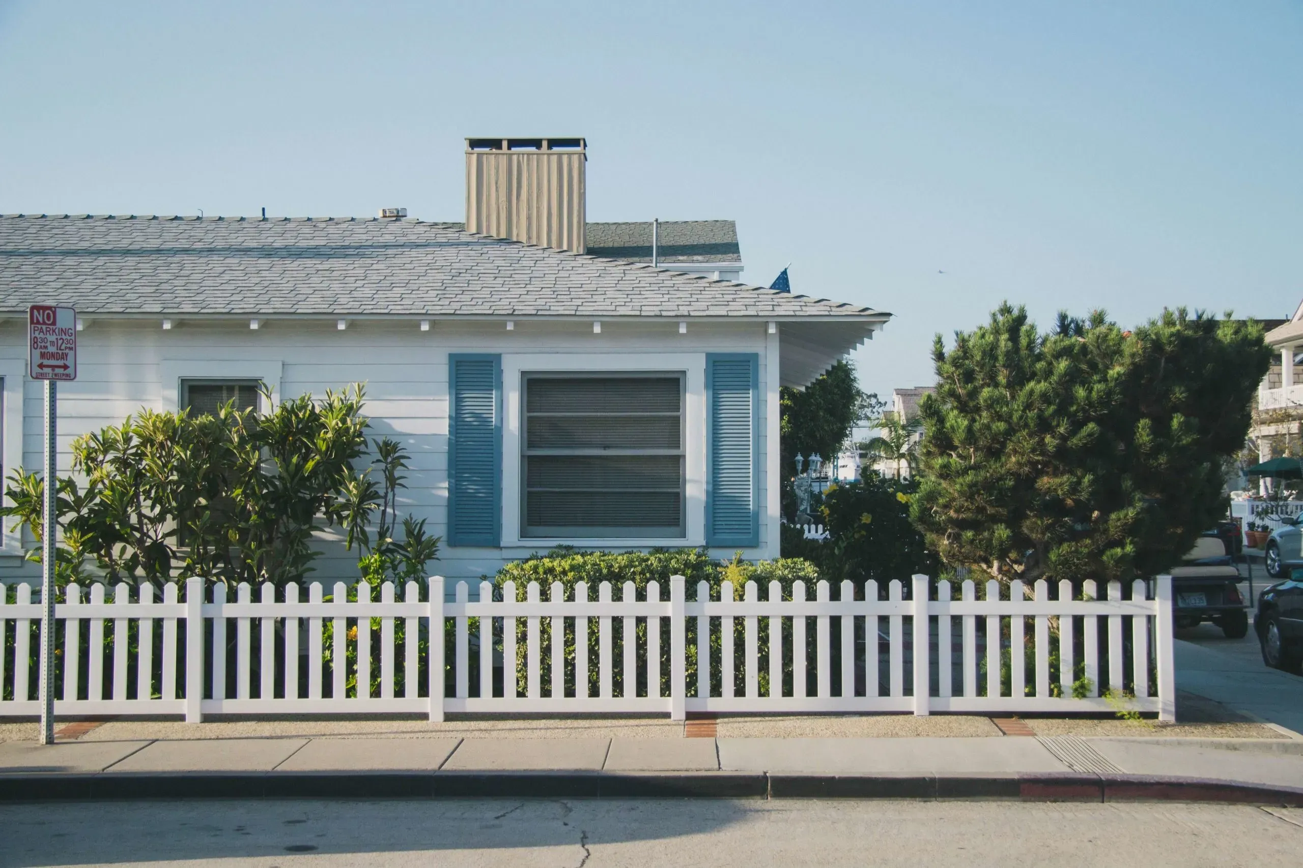 a white picket fence in front of a house